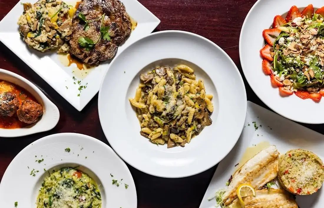 A spread at 660 LIVE — ribeye with mushroom risotto, cavatelli with wild mushrooms, strawberry salad, meatballs and a plated fish course.