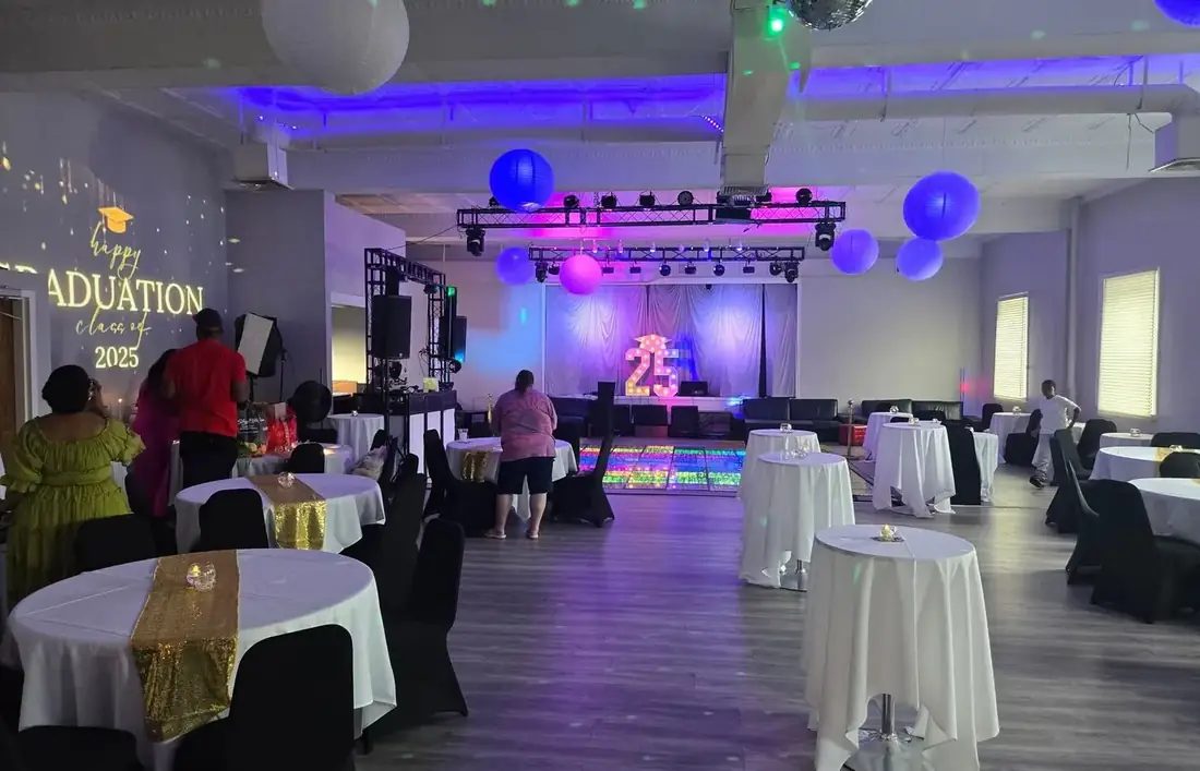 The Loft at 660 set for a graduation party — cocktail tables, a lit LED dance floor, disco ball and truss lighting.