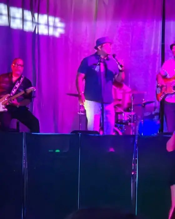 A live band on the stage in The Loft at 660 lit purple, the crowd watching from the floor.